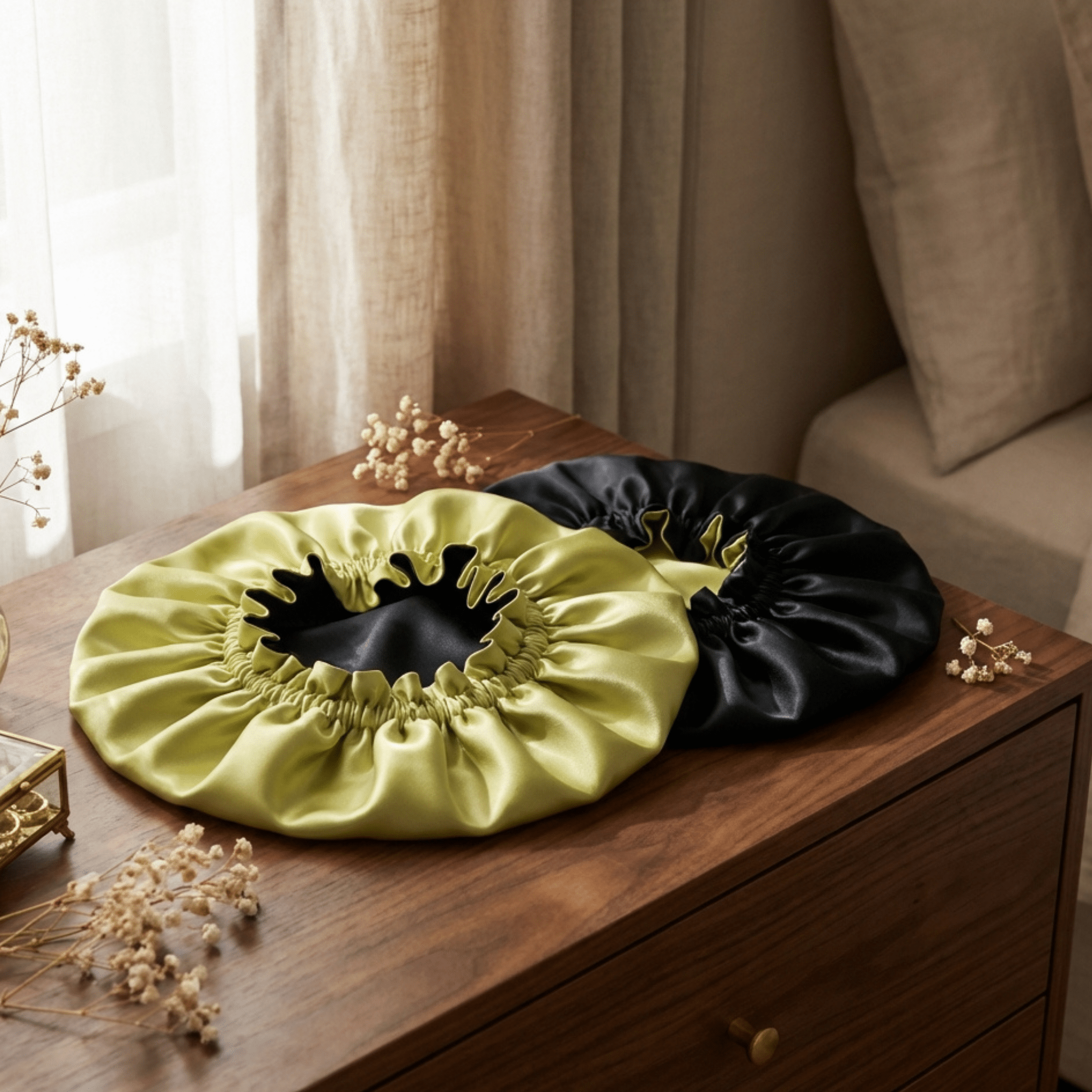 Chartreuse and black silk bonnet placed on wooden dresser in bedroom lifestyle setting
