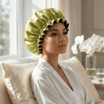 Woman wearing chartreuse and black mulberry silk bonnet for hair protection while relaxing at home
