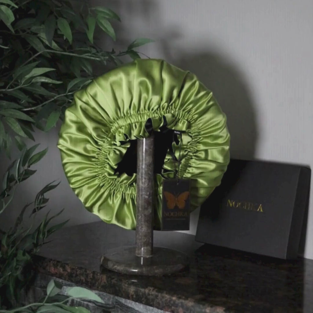 Top view of chartreuse and black reversible mulberry silk bonnet showing gathered elastic opening